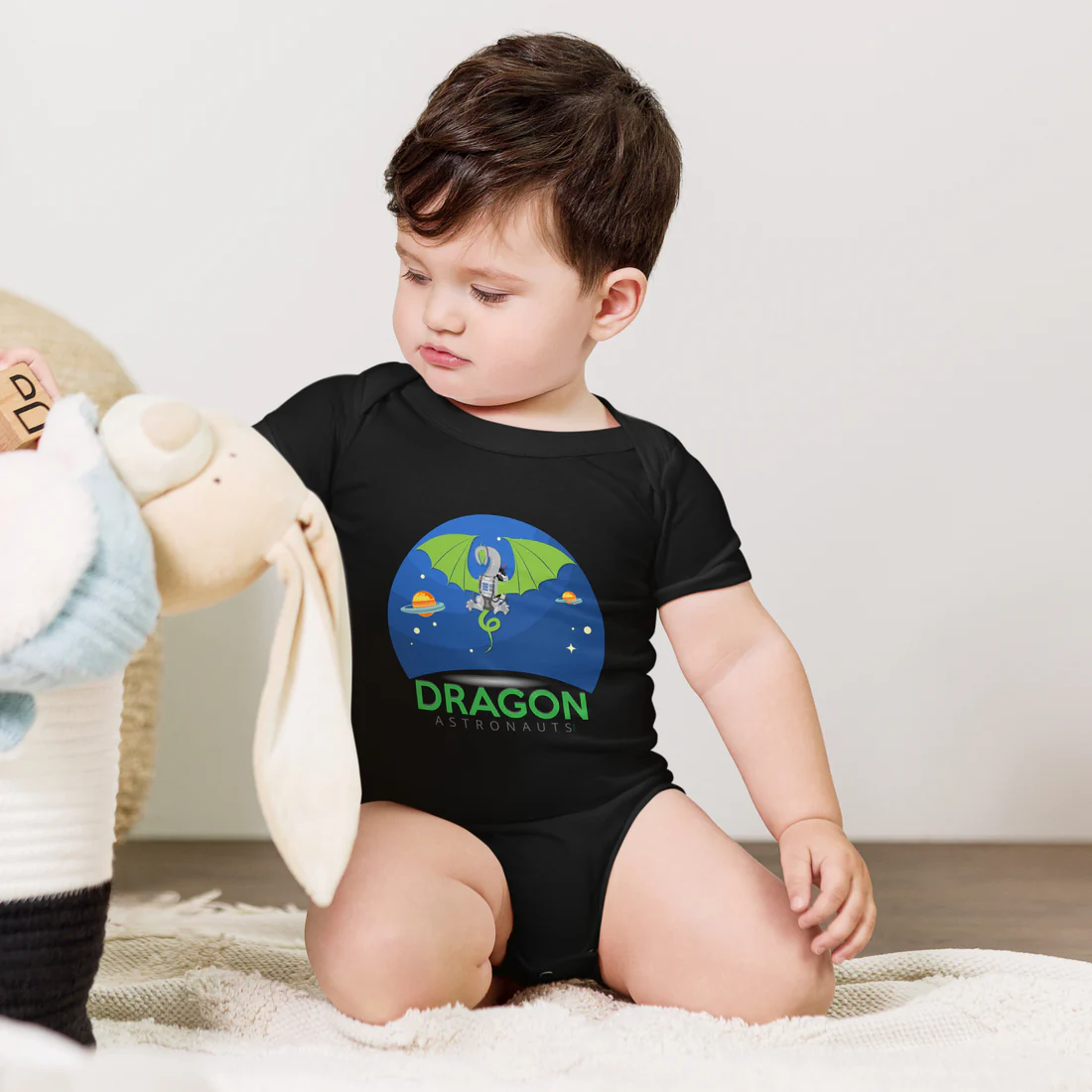 Baby in Dragon Astronauts onesie